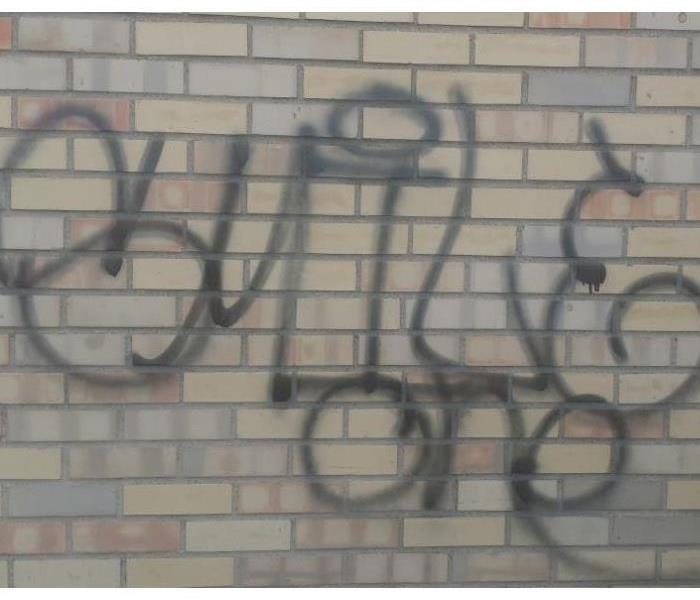 vandalized brick wall