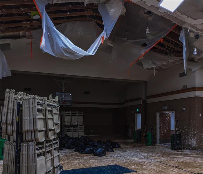 gym after a sprinkler pipe burst sending debris onto the floor below
